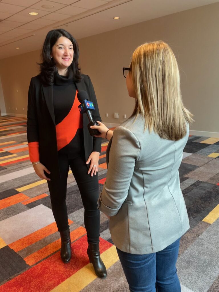 A reporter is holding a microphone to interview another woman.
